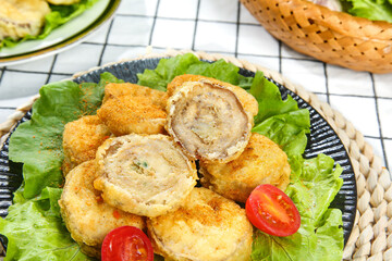 Deep Fried Eggplant Rolls with Savory Filling Served on Fresh Lettuce Leaves