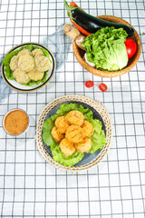Chinese Fried Eggplant Pancakes with Fresh Vegetables and Cooking Ingredients on Checkered Kitchen Surface