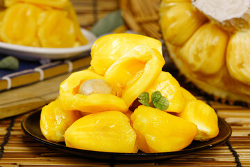 Fresh Thai Jackfruit Segments - Golden Yellow Tropical Fruit with Sweet Honey Flavor on Bamboo Mat