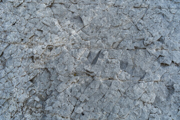 Layered rocks, flysch texture background. Sedimentary rock, striations stone pattern