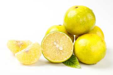 Fresh Yellow Citrus Fruits with Peeled Segments and Green Leaf on White Background