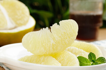 Fresh Thai Pomelo Citrus Segments in White Bowl with Mint Garnish