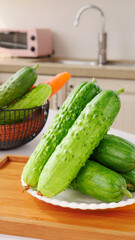 Fresh Green Spiny Cucumbers on Kitchen Counter with Vegetables