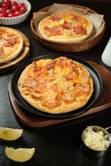 Tempting Italian Pizza with Melted Cheese and Pepperoni on Rustic Wooden Table - Delicious Homemade Food