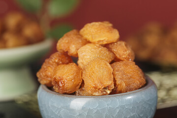 Dried Longan Fruit Pieces in Bowl - Traditional Chinese Sweet Snack Food