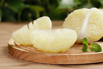 Fresh Thai White Pomelo Segments on Wooden Board with Mint Leaves - Healthy Citrus Fruit