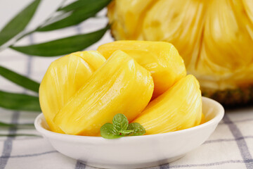 Fresh Thai Pineapple Slices with Golden Honey-Colored Flesh in White Bowl with Mint Garnish
