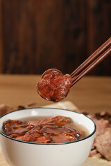 Fototapeta premium Dried Red Porcini Mushrooms with Chopsticks - Healthy Asian Cooking Ingredients for Hotpot
