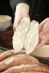 Fresh Cooked Sweet Potato Halves in Hands - Healthy Root Vegetable Food Preparation