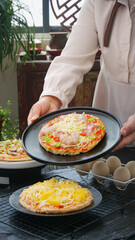 Chef Serving Delicious Italian Pizza with Cheese and Fresh Toppings in Restaurant Kitchen