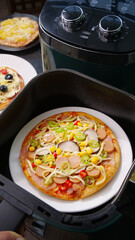 Homemade Pizza with Vegetables and Meat Cooking in Air Fryer Kitchen Appliance