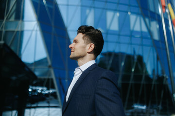 Side Portrait of Stylish Man in Suit Smiling in the City