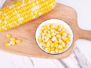 Fresh Golden Corn Kernels in Bowl with Whole Cob on Wooden Board - Natural Sweet Corn Food Ingredient