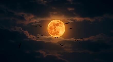 Dark cloudy night sky with a glowing orange harvest moon and flying bats