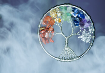 Tree of life made from colourful stones and metal wire withs swirling smoke and mist hand made by photographer Asia