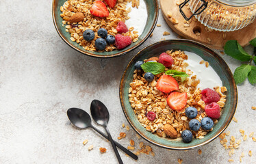 Granola bowls with yogurt, berries, and mint for breakfast