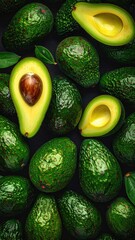Avocados Whole and halved, green skins, dark backdrop