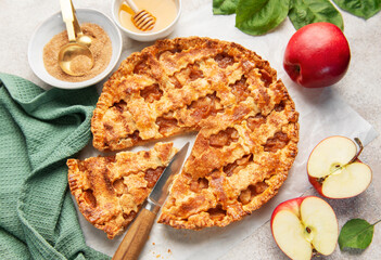 Homemade apple pie with ingredients on concrete background