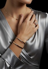 Elegant jewelry display on womans hand and wrist against silk fabric