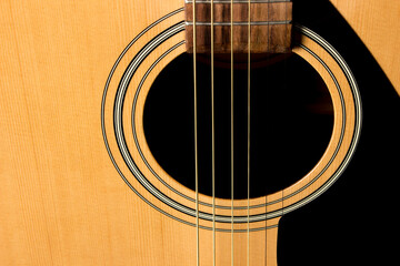 Obraz premium acoustic guitar on a black background. close-up.