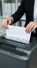 Woman shredding paper in office. Document destruction for privacy and security. Data protection concept for banner or poster, news or blog post.