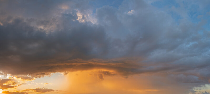Cumulonimbus capillatus storm cloud illuminated by the setting sun - Powered by Adobe
