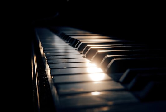Close-up of a Piano Keyboard with Light Reflections Creating a Dramatic Atmosphere
