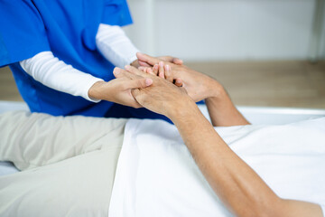 Fototapeta premium Caring therapist supports senior patient by holding hands. healthcare, elder care, rehab, emotional healing, human touch, and trust in medical environments.