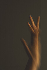 Abstract photo with blurred hands of a woman dancing.