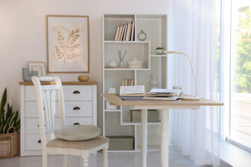 Stylish living room with table, chair and shelving unit. Interior design