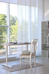 Stylish living room with table, chair and shelving unit. Interior design