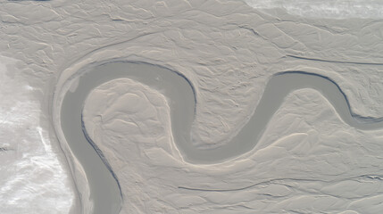 A stunning aerial view from space of a massive, sinuous sand dune resembling a slug, dramatically...