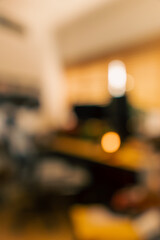 Cozy vintage desk setup featuring warm lighting, monitor, keyboard, gaming chair and gadgets in a studio workspace. Perfect background for productivity, lifestyle and workstation themes.