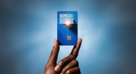 Hand holding a blue credit card for payment concept
