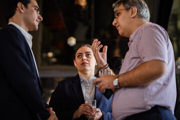 Corporate professionals meeting at a social business gathering, highlighting organizational culture, collaboration, and modern business communication styles.