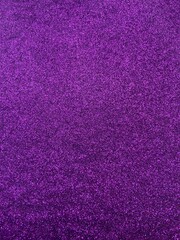 Purple glitter surface with uniform shimmer and vibrant reflections — glamorous, abstract texture for fashion, celebration, or design mood