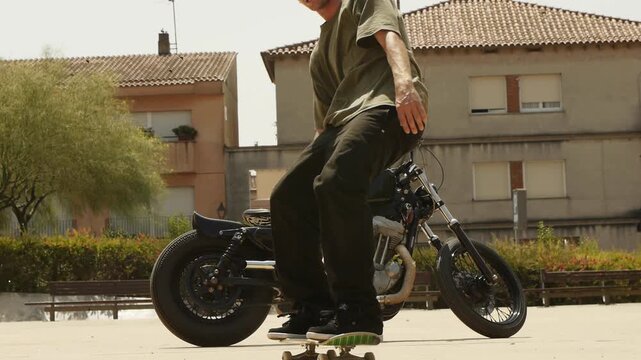 Skater performing trick switch ollie with motorcycle in background under harsh sunlight