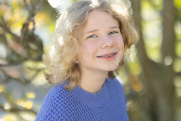 Fototapeta premium Young blonde girl teenager smiling wearing dental braces