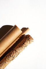 Kraft Paper Rolls on White Backdrop. Holiday Gifts Packaging.  