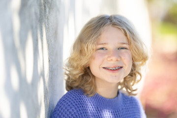 Fototapeta premium Young girl smiling with braces on sunny day
