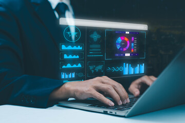 Businessman using laptop with futuristic digital dashboard showing analytics, charts, and AI data visualization, concept of business intelligence, big data, financial report