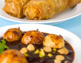 Close-up of savory pastries and a sauce with boiled eggs