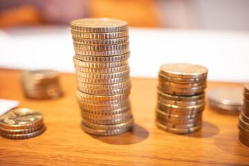 Stacks of euro coins on wooden table