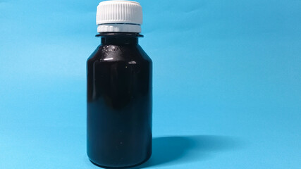 Dark liquid medicine in a bottle ready to cure your pain and provide relief from terrible symptoms
