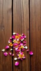 Fototapeta premium Vibrant flower petals and blooms scattered across a rustic wooden surface, full sun.