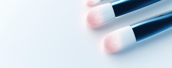 Set of three professional makeup brushes with soft bristles, arranged on a clean white background, showcasing beauty tools for makeup application and artistry