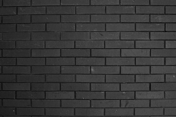 Close up of black brick wall, showcasing modern, sleek texture. Ideal for use as background in design projects, or as strong, minimalist feature in architecture, photography and branding