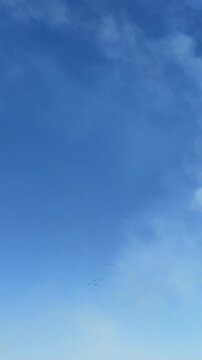 Air show Frecce Tricolori: A captivating image of the clear, azure sky, where the sun's embrace paints subtle hues, and wisps of clouds dance