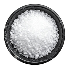 Macro closeup of white sea salt crystal powder in a clear glass bowl on a wood kitchen surface