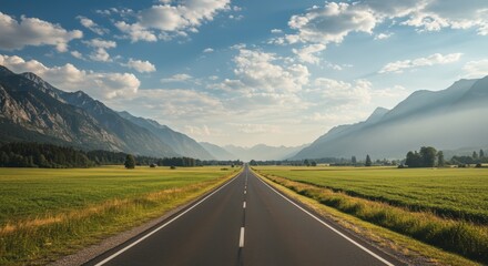 Naklejka premium Scenic highway through a valley with mountains and fields under a blue sky with clouds a landscape